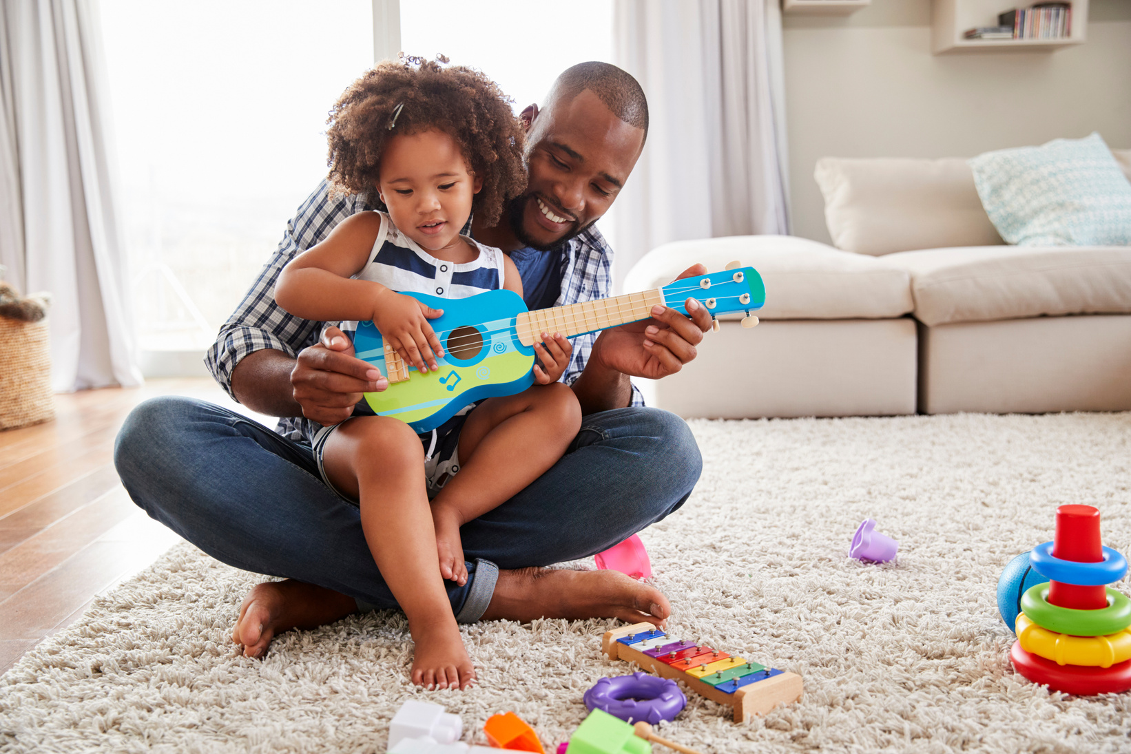 Toddler Daughter Sits on Dad 