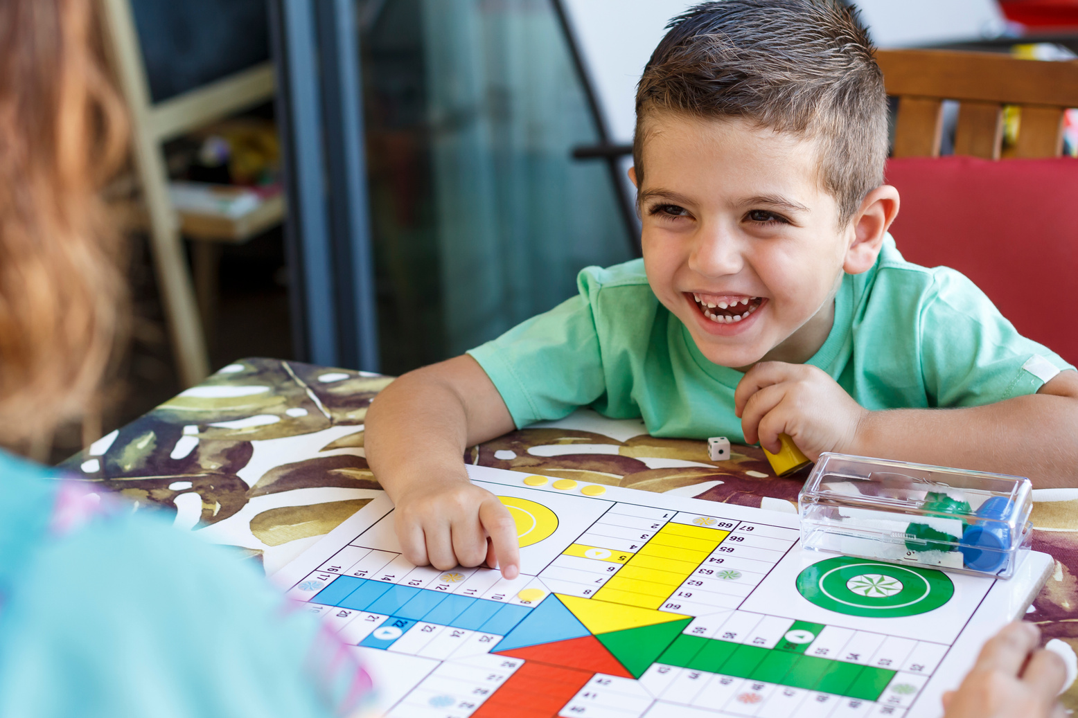 Little Boy Playing Ludo with His Mother on Vacation